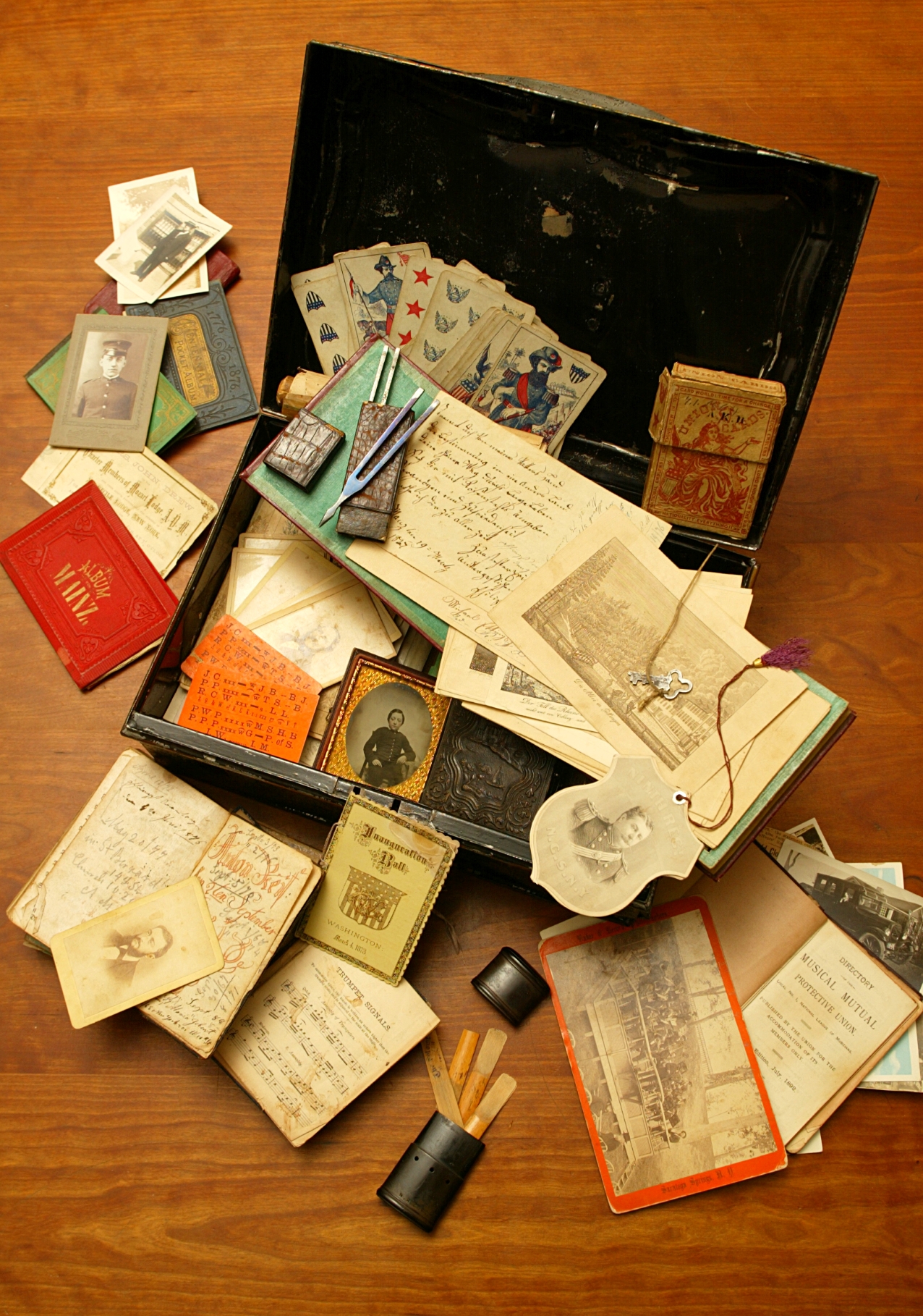 A large strongbox filled with tuning forks, clarinet reeds, family portraits, and other miscellany.